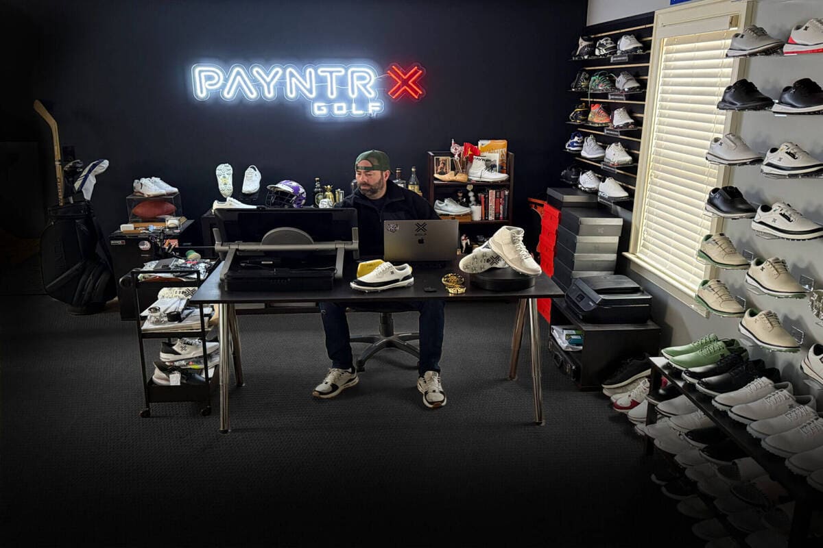 PAYNTR GOLFのオフィスに並ぶゴルフシューズと開発機材のディスプレイ