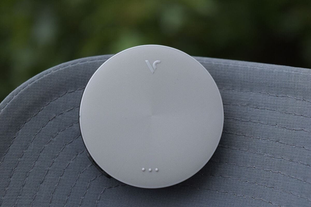 ボイスキャディ VC4（Voice Caddie VC4）の本体デザイン。丸型の薄型GPSデバイスが帽子のつばに取り付けられている様子をクローズアップで撮影。